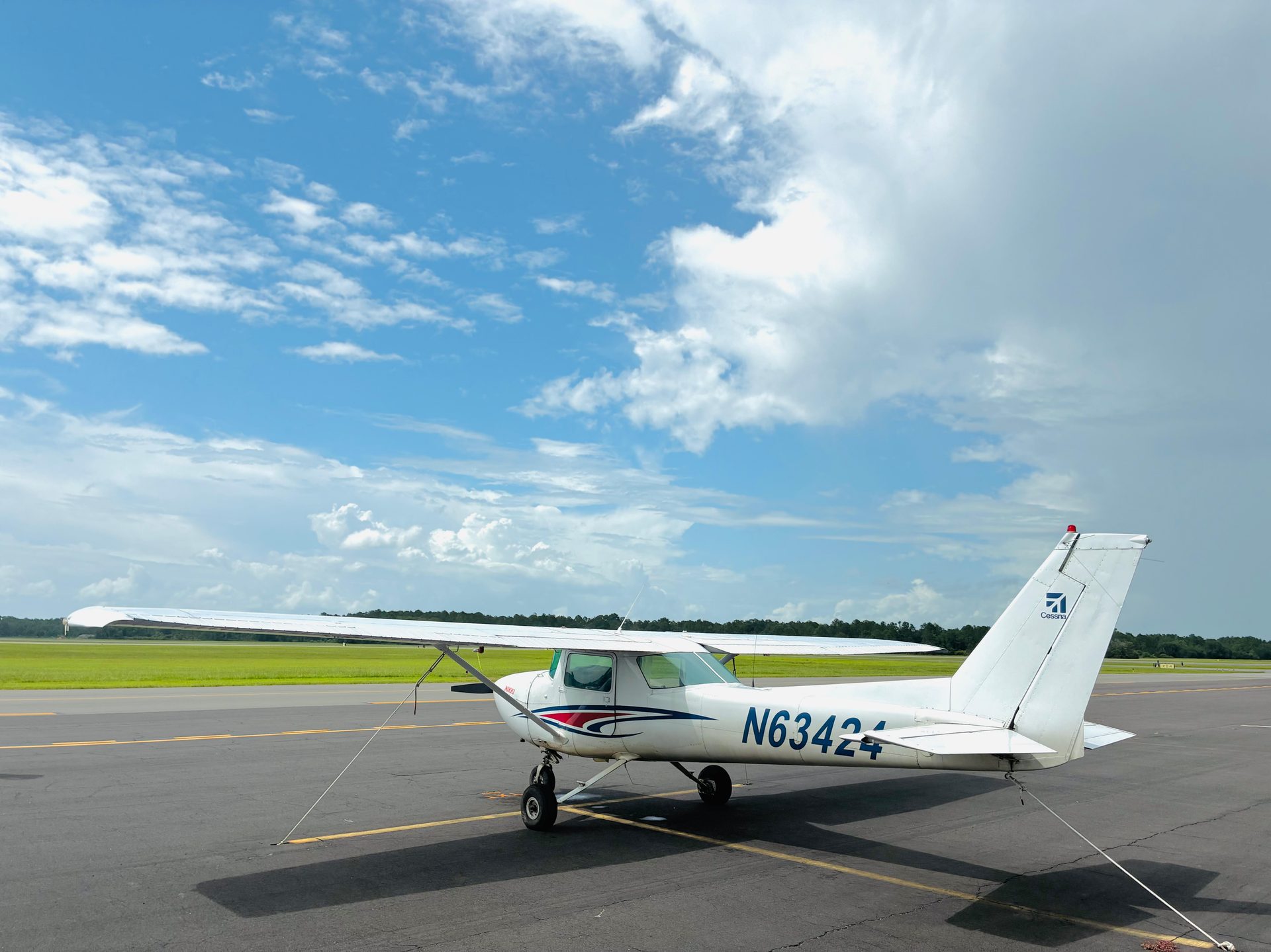 Cessna 150 N63424 parked on the ramp under a blue sky